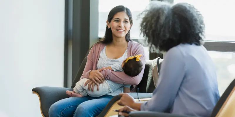 A couple navigating a supportive conversation about postpartum mental health struggles together