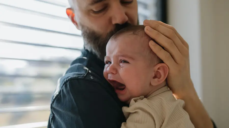 A new father experiencing the isolation and quiet struggle of postpartum adjustment