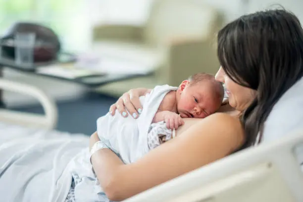 A serene photo of a newborn on a parent's chest for skin-to-skin contact