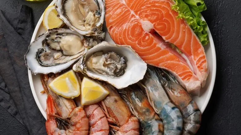 A colorful display of various seafood options with a small note card indicating