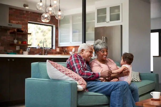 A multigenerational family gathered comfortably in a living room