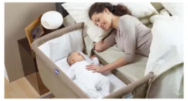 A safe sleep setup showing a baby in a bassinet next to the parents' bed