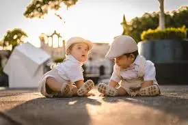 A warm, hopeful image of two tiny, matching hats or pairs of socks, symbolizing the preparation for two babies