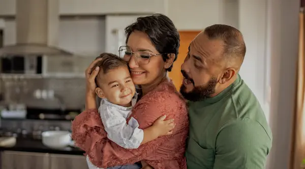 Parent and child reconnecting with calm, focused attention after a separation.