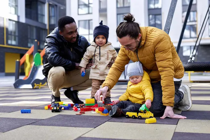 Two parents and a toddler at a playground