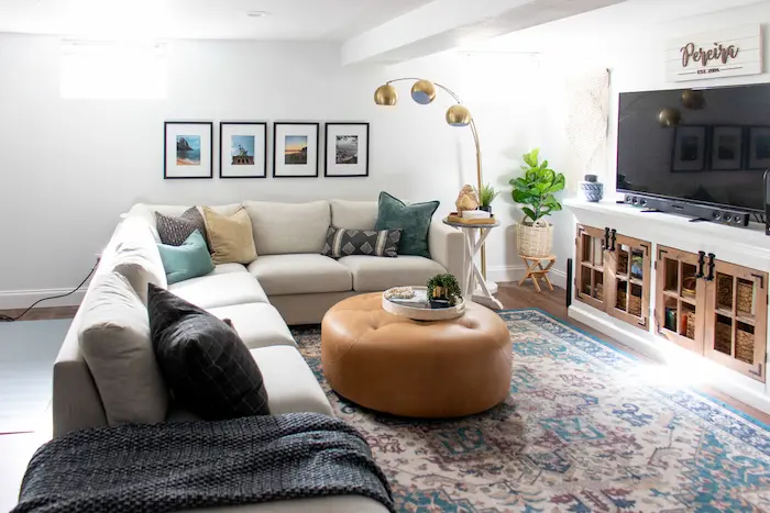 A photo from a baby’s-eye view: a safe, inviting living room floor with a few soft toys, a stable coffee table with padded corners in the background
