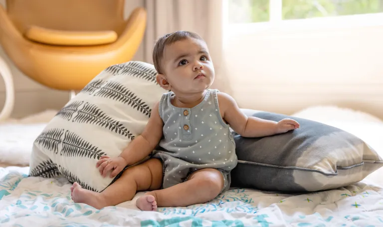 practicing sitting down in crib